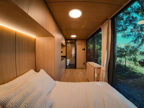 Mirror cabin disappearing into Canadian forest surroundings